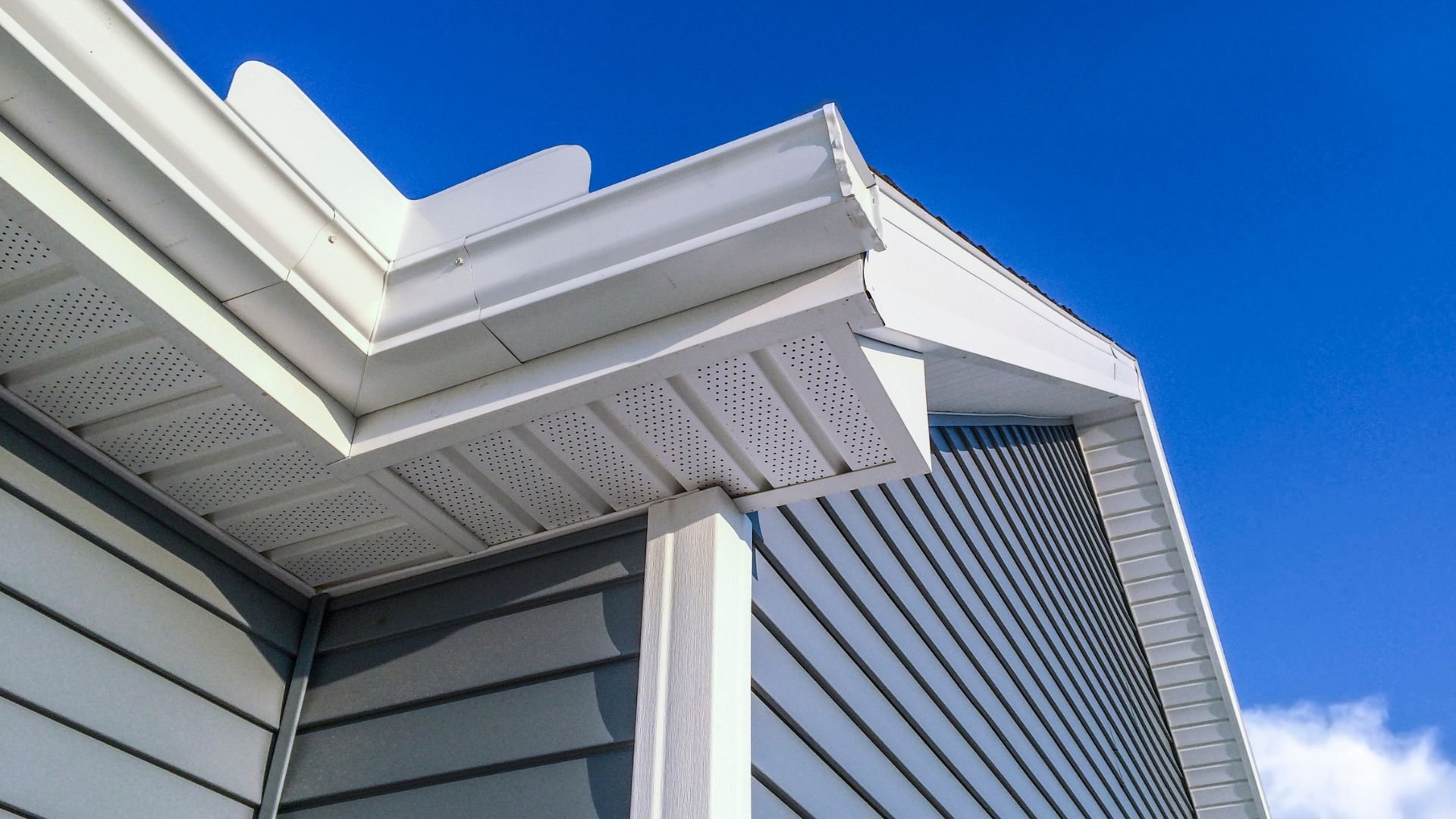 White and gray modern building exterior with geometric roof details